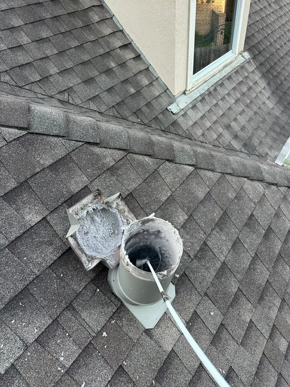 Rotary brush running through a roof dryer vent