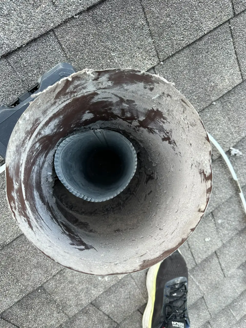 Roof dryer vent lined with lint